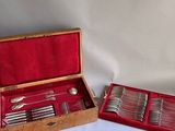 a wooden box with silverware in it on a table