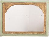 a mirror with a gold frame on a white wall