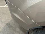 a close up of a car with a denting on the front of it