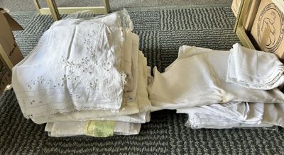 a pile of folded towels on the floor next to a chair