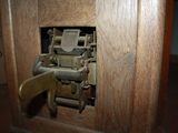 a wooden door with a lock on it and a box in the background