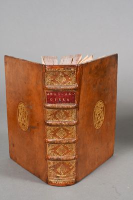 an old book that is open on a table