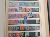 a book with stamps on the pages and a picture of a man