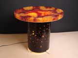 a table with a lamp on top of it on a table