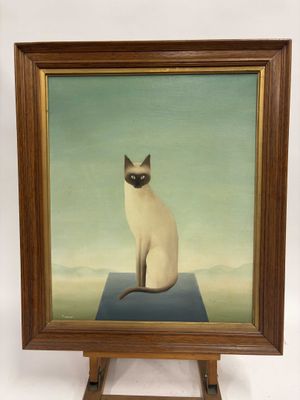 tableau représentant un chat siamois assis sur une table bleue