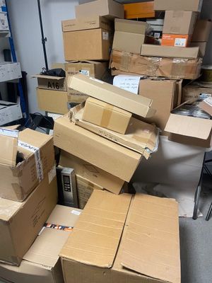 many boxes stacked on top of each other in a room