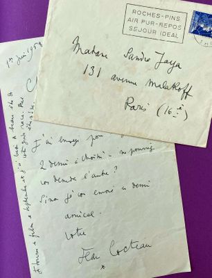 two envelopes with handwritten letters on them on a purple surface