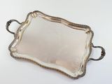 an antique silver tray with handles and handles on a white surface