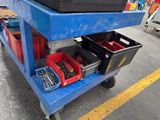 a blue cart with tools on it in a warehouse