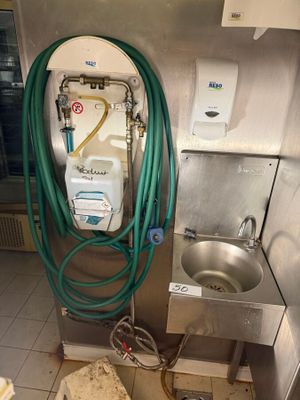 an image of a kitchen with a sink and a hose