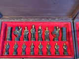 chess pieces in a case with red linings on a table