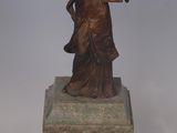 statue of a woman holding a bird on a marble base