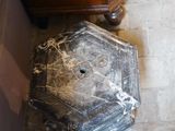 a marble block sitting on the floor next to a wooden cabinet