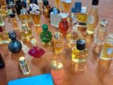 many bottles of perfume sitting on a table with a price tag