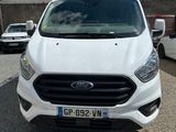ford transit van parked in a parking lot with other vehicles in the background