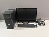 a desktop computer sitting on a desk with a keyboard and mouse