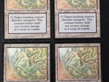 quatre cartes aux motifs différents posées sur une surface noire