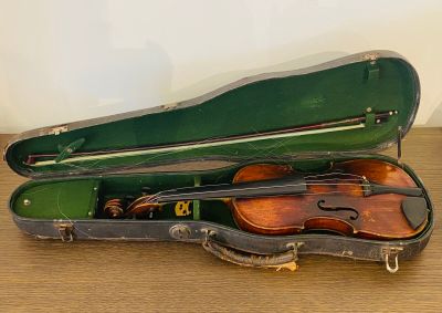 un violon posé dans son étui sur une table