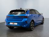the rear end of a blue car parked in a room