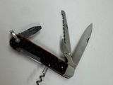 a small swiss army knife with a corkscrew on it