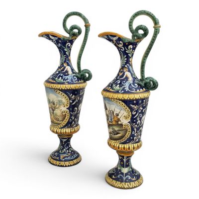 pair of blue and gold vases with a painting of a man and a woman on them