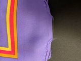 purple square with multi - colored stripes on it on a black surface