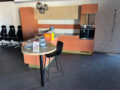 a kitchen with a table and chairs in the middle of the room