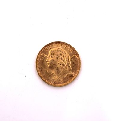 a close up of a gold coin on a white surface