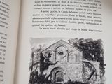 an open book with a drawing of a church on it