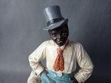 a figurine of a man wearing a top hat and tie