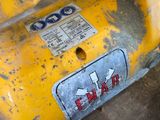 a close up of a yellow fire hydrant with a sticker on it