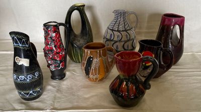 many different colored vases sitting on a table