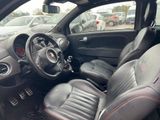 the interior of a small car with leather seats and a steering wheel