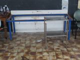 a metal table with a glass top on a tiled floor