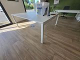a white table in the middle of a room