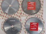 three circular saw blades are sitting on a sheet of paper