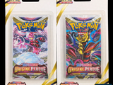 two packs of pokemon trading cards in plastic packaging on a black background
