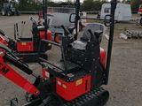 a small red machine that is sitting in the dirt