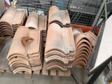 a lot of roof tiles on the ground in the yard