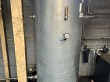 a water heater in the corner of a room