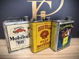 three tins that are sitting on a table