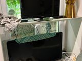 a television on a stand in the corner of a living room