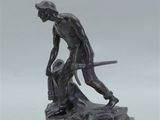statue of a man with a sword and a dog on a marble base