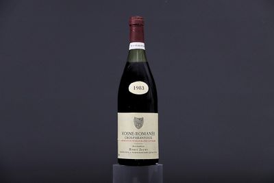 a bottle of wine sitting on top of a black table