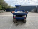 a blue dump truck that is parked in a parking lot