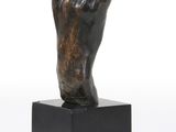 bronze sculpture of a hand on a black square base