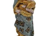 figurine of mary holding a child on a wooden base