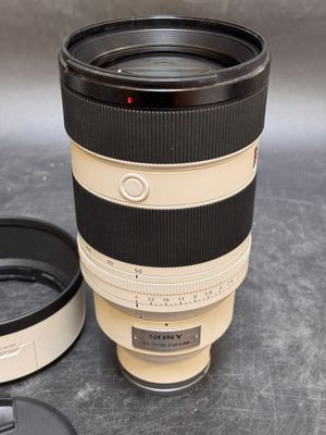 a camera lens sitting next to a cup on a table