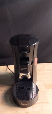a coffee maker that is sitting on a wooden table