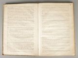 an open book with writing on it sitting on top of a table